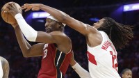 Toronto Raptors forward Collin Murray-Boyles (12) defends Miami Heat center Bam Adebayo (13) during the second half at Kaseya Center.