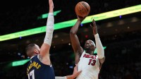 Miami Heat center Bam Adebayo (13) shoots the basketball over Denver Nuggets center Jonas Valanciunas (17) during the third quarter at Kaseya Center.