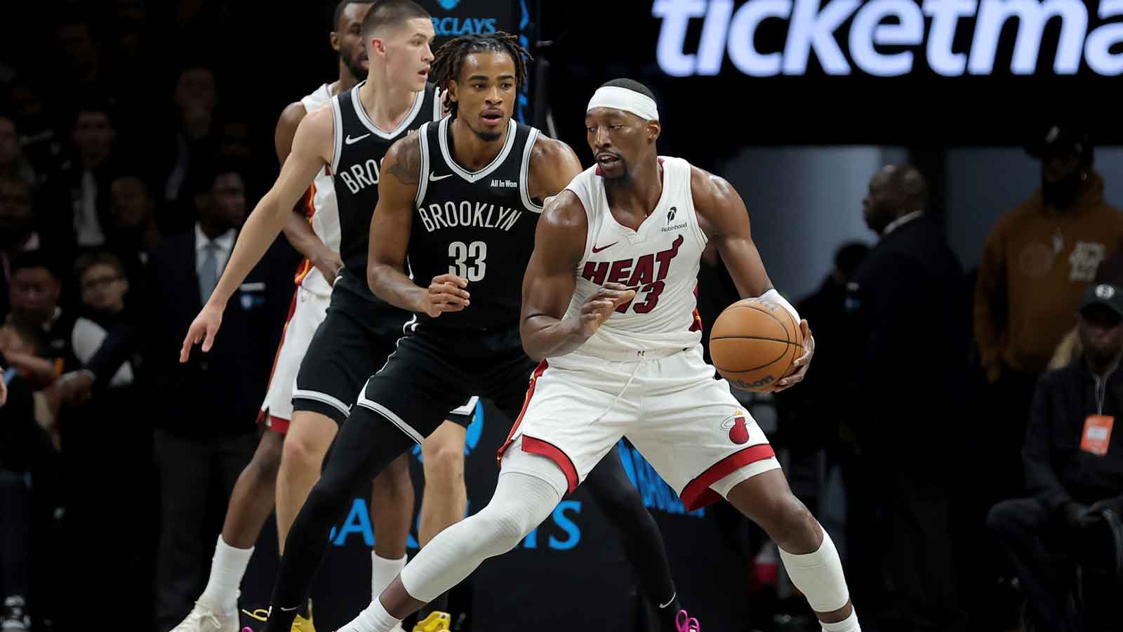 Miami Heat center Bam Adebayo (13) controls the ball against Brooklyn Nets center Nic Claxton (33) during the first quarter at Barclays Center.