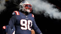 New England Patriots defensive tackle Christian Barmore (90) walks out of the tunnel before a game against the Atlanta Falcons at Gillette Stadium.