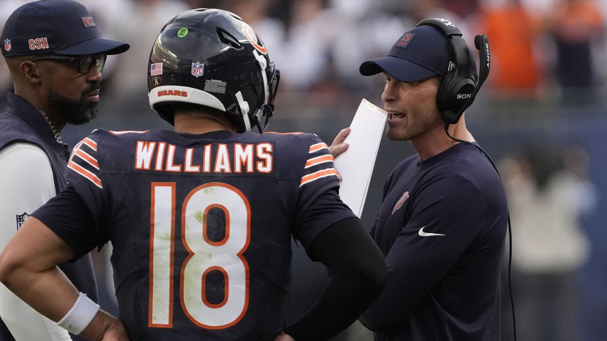 Chicago Bears head coach Ben Johnson talks with quarterback Caleb Williams (18) against the Dallas Cowboys during the second half at Soldier Field.