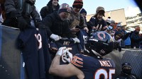 Chicago Bears tight end Cole Kmet (85) autographs a jersey after the game against the Cleveland Browns at Soldier Field.