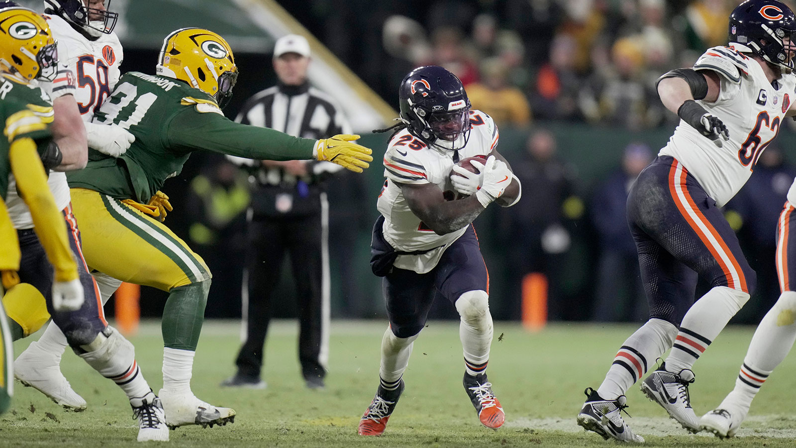 Chicago Bears running back Kyle Monangai (25) runs past Green Bay Packers defensive tackle Warren Brinson (91) during the second quarter of their game Sunday, December 7, 2025 at Lambeau Field in Green Bay, Wisconsin