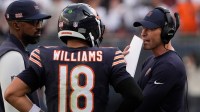 Chicago Bears head coach Ben Johnson talks with quarterback Caleb Williams (18) against the Dallas Cowboys during the second half at Soldier Field.