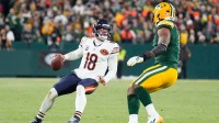 Chicago Bears quarterback Caleb Williams (18) looks for an open receiver during the fourth quarter against the Green Bay Packers at Lambeau Field. Mandatory Credit: