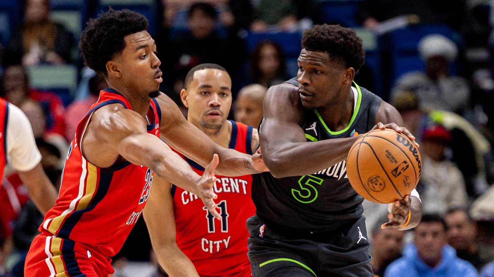 Minnesota Timberwolves guard Anthony Edwards (5) passes the ball around New Orleans Pelicans forward Trey Murphy III (25) during the first half at Smoothie King Center.
