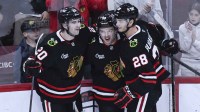 Chicago Blackhawks center Connor Bedard (98) celebrates with center Ryan Greene (20) and left wing Andre Burakovsky (28) after he scores a goal against the Anaheim Ducks during the third period at United Center.