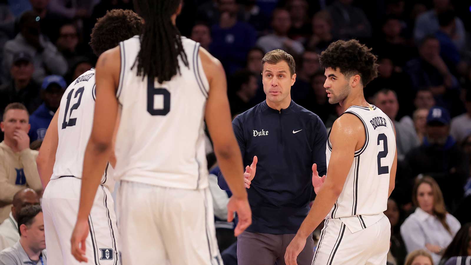 Duke Blue Devils head coach Jon Scheyer talks to Duke Blue Devils forwards Cameron Boozer (12) and Maliq Brown (6) and guard Cayden Boozer (2) during the second half against the Texas Tech Red Raiders at Madison Square Garden.