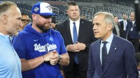 Toronto Blue Jays President and CEO Mark Shapiro (left) and manager John Schneider (center) listen to Canadian Prime Minister Mark Carney during media day before game one of the World Series against the Los Angeles Dodgers at Rogers Centre.