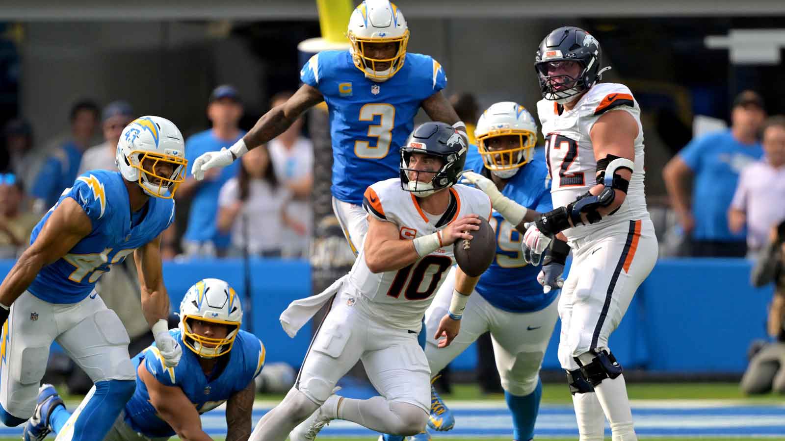 Denver Broncos quarterback Bo Nix (10) scrambles in the pocket in the second half against the Los Angeles Chargers at SoFi Stadium.