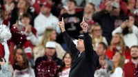 Former coach Bob Stoops waves to the crowd as he is introduced during a college football game between the University of Oklahoma Sooners (OU) and the Alabama Crimson Tide at Gaylord Family - Oklahoma Memorial Stadium in Norman