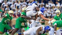 Notre Dame Fighting Irish defensive lineman Jared Dawson (93) hits Boise State Broncos running back Sire Gaines (26) as he jumps over tacklers during the second half at Notre Dame Stadium.
