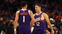 hoenix Suns guard Devin Booker (1) and Collin Gillespie (12) against the Sacramento Kings during the season opener at the Mortgage Matchup Center.
