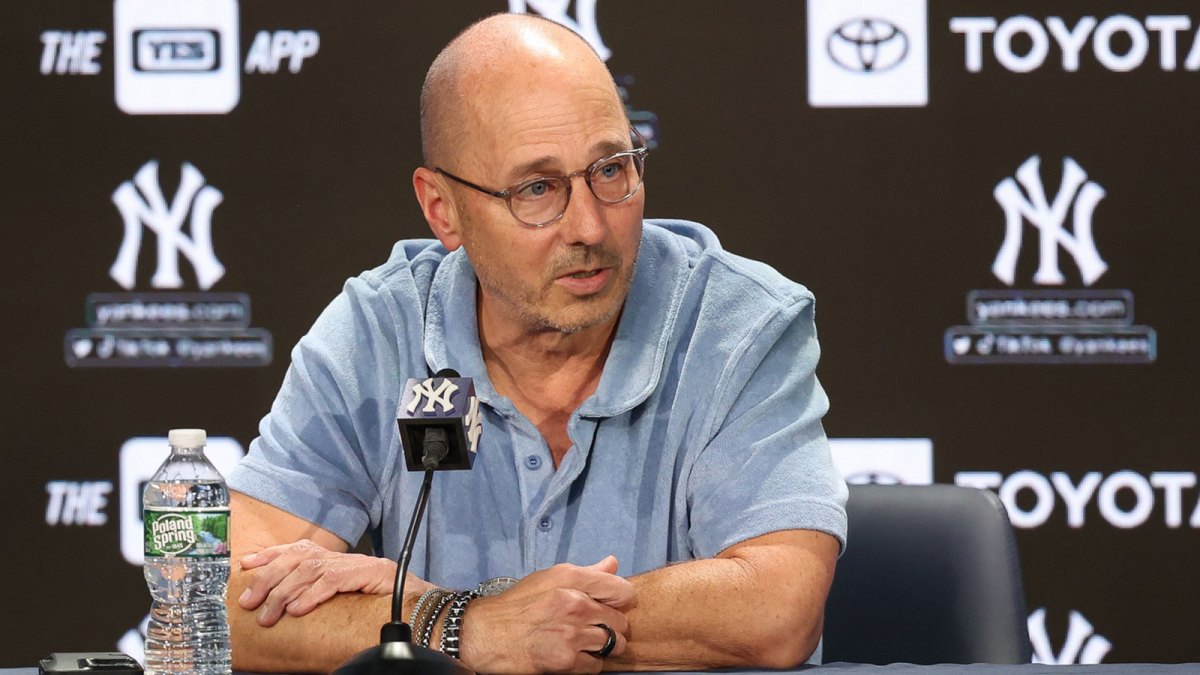 New York Yankees general manager Brian Cashman talks with the media before the game between the Yankees and the Washington Nationals at Yankee Stadium.