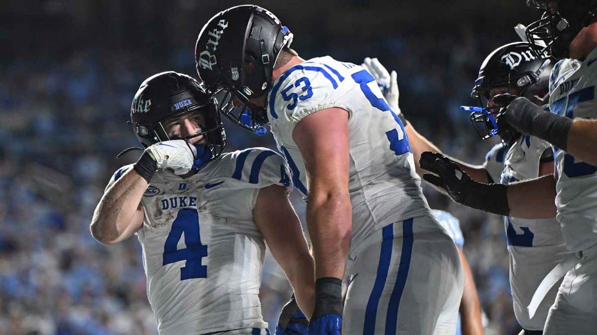 Duke Blue Devils running back Anderson Castle (4) celebrates a touchdown with offensive lineman Brian Parker II (53) during the second half against North Carolina at Kenan Stadium.