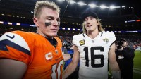 Denver Broncos quarterback Bo Nix (10) and Jacksonville Jaguars quarterback Trevor Lawrence (16) meet after the game at Empower Field at Mile High.