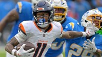 Denver Broncos wide receiver Troy Franklin (11) pushes off Los Angeles Chargers cornerback Tarheeb Still (29) as he runs the ball in the second half at SoFi Stadium