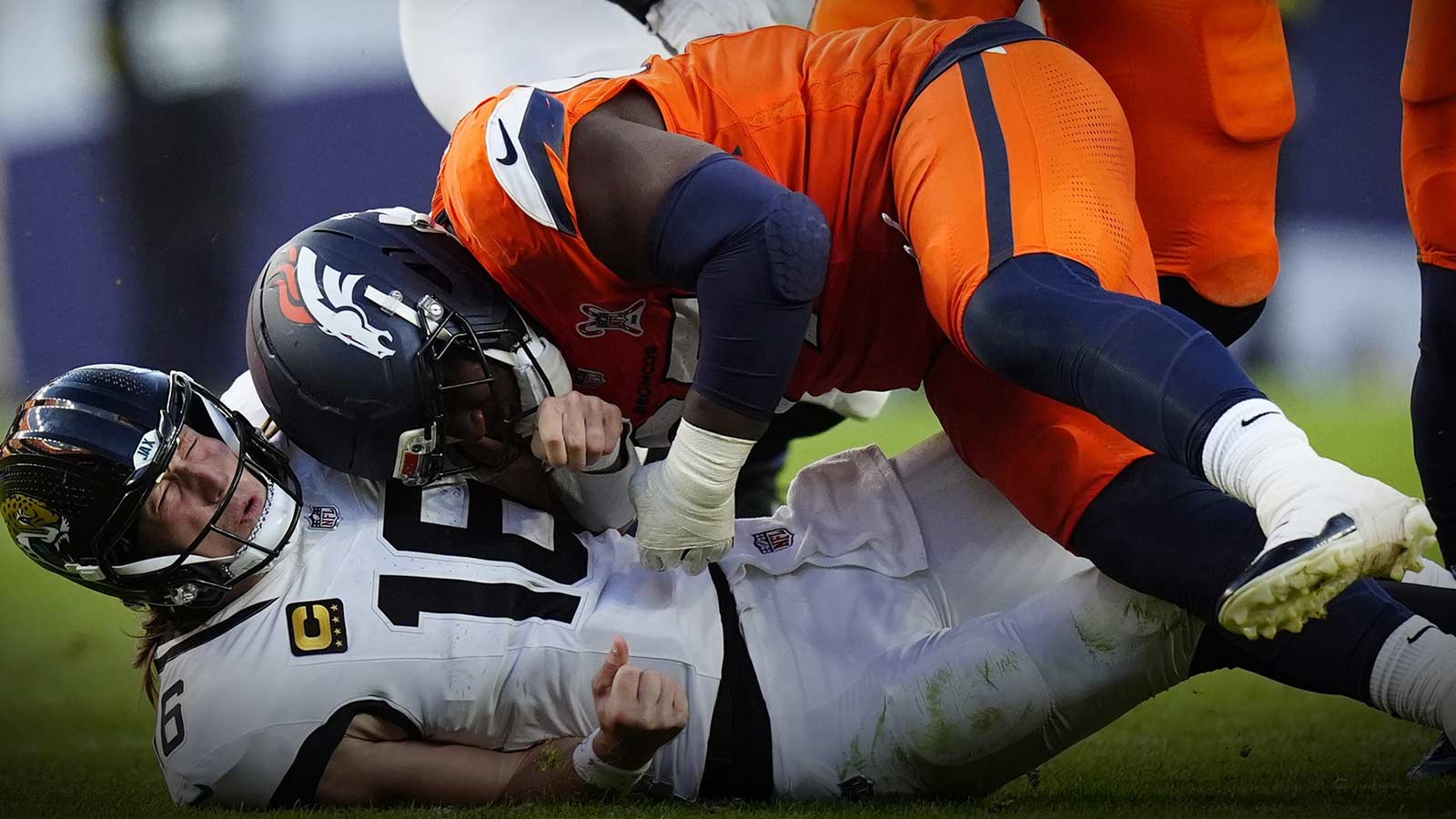 Denver Broncos defensive tackle Malcolm Roach (97) hits Jacksonville Jaguars quarterback Trevor Lawrence (16) during the second half at Empower Field at Mile High.
