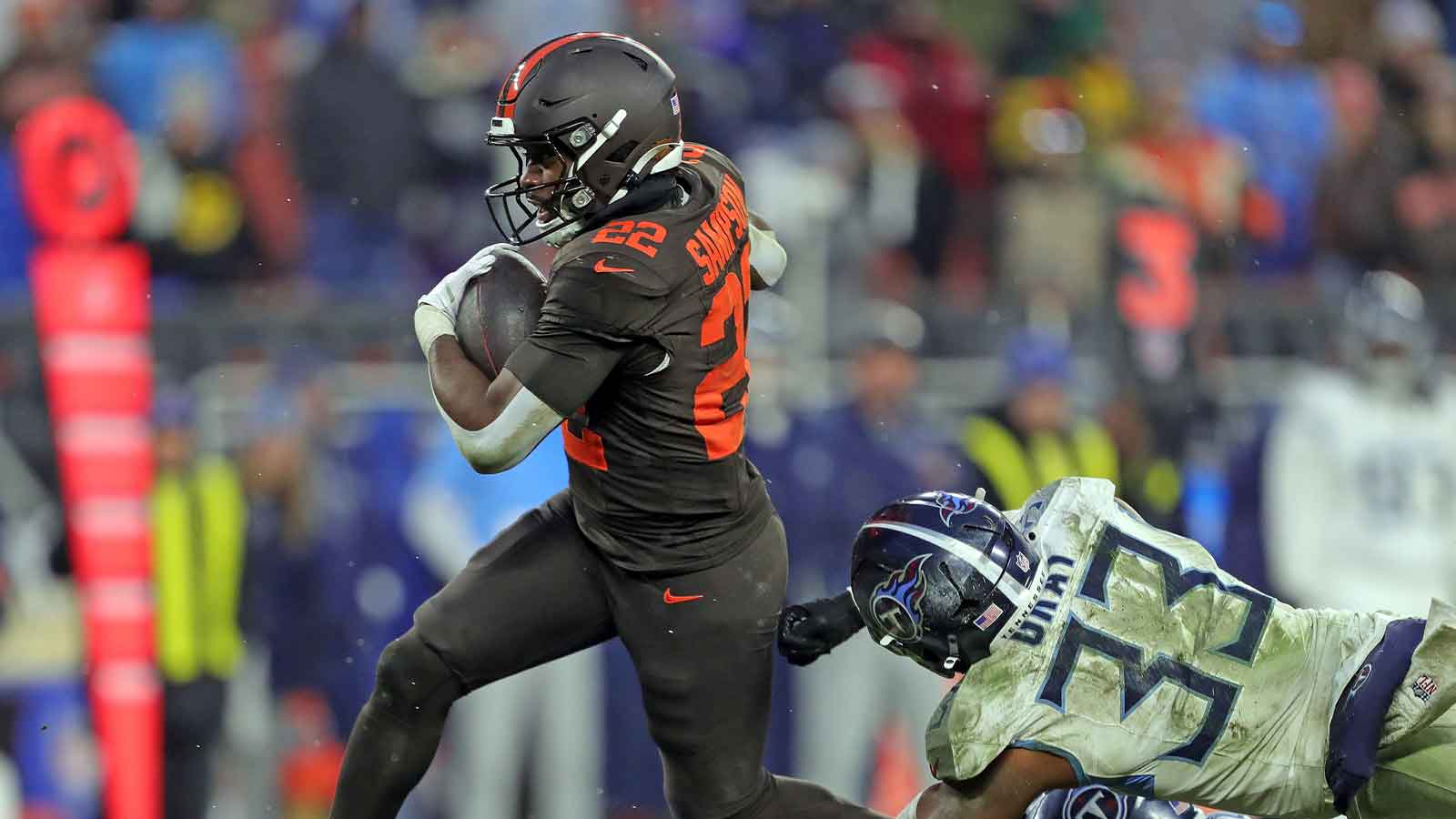 Cleveland Browns running back Dylan Sampson (22) breaks away from Tennessee Titans linebacker Cedric Gray (33) for a first down during the second half of an NFL football game at Huntington Bank Field, Dec. 7, 2025, in Cleveland, Ohio.