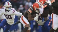 Cleveland Browns running back Quinshon Judkins (10) carries the ball as Buffalo Bills defensive end Greg Rousseau (50) defends during the first half at Huntington Bank Field.