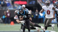 Tampa Bay Buccaneers defensive end Logan Hall (90) tackles Carolina Panthers quarterback Bryce Young (9) during the second half at Bank of America Stadium.