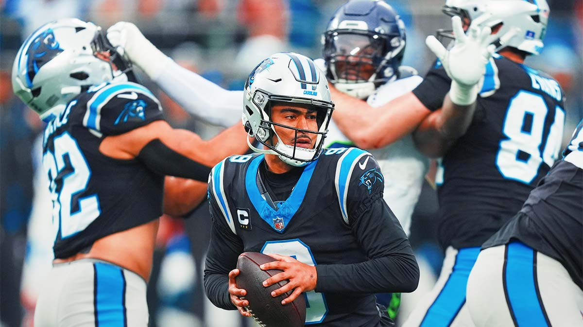 Carolina Panthers quarterback Bryce Young (9) looks to throw a pass as tight ends Tommy Tremble (82) and Mitchell Evans (84) block against Seattle Seahawks defensive end Leonard Williams (99) during the third quarter at Bank of America Stadium.