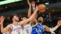 Bucks forward Giannis Antetokounmpo (34) reaches for the ball against Oklahoma City Thunder center Chet Holmgren (7) and forward Jaylin Williams (6) in the fourth quarter at Fiserv Forum