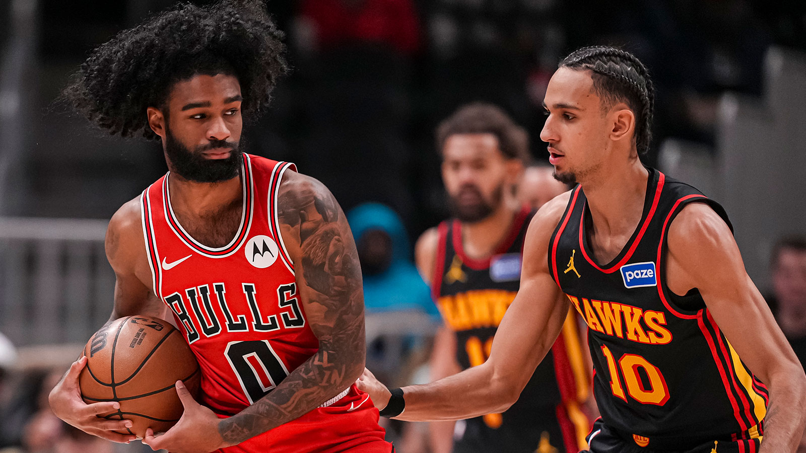 Chicago Bulls guard Coby White (0) controls the ball against Atlanta Hawks forward Zaccharie Risacher (10) during the first half at State Farm Arena.
