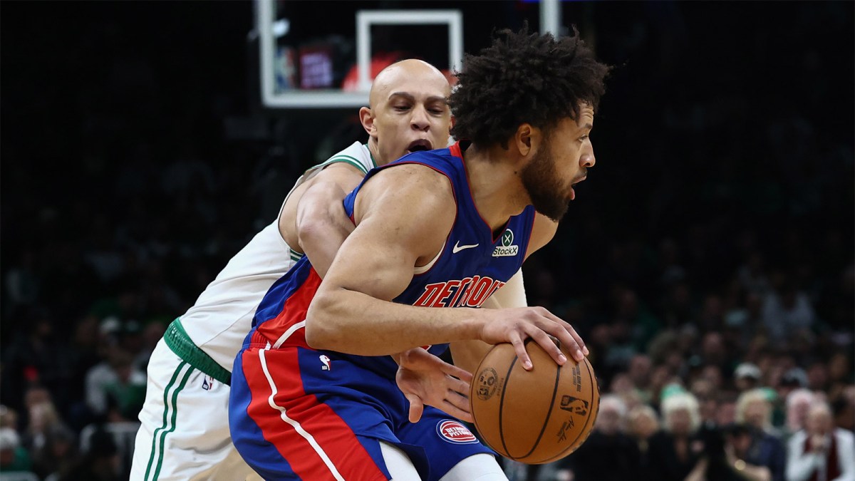Boston Celtics guard Jordan Walsh (27) reaches in from behind to try to knock the ball away from Detroit Pistons guard Cade Cunningham (2) during the first quarter at TD Garden.
