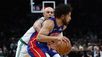 Boston Celtics guard Jordan Walsh (27) reaches in from behind to try to knock the ball away from Detroit Pistons guard Cade Cunningham (2) during the first quarter at TD Garden.