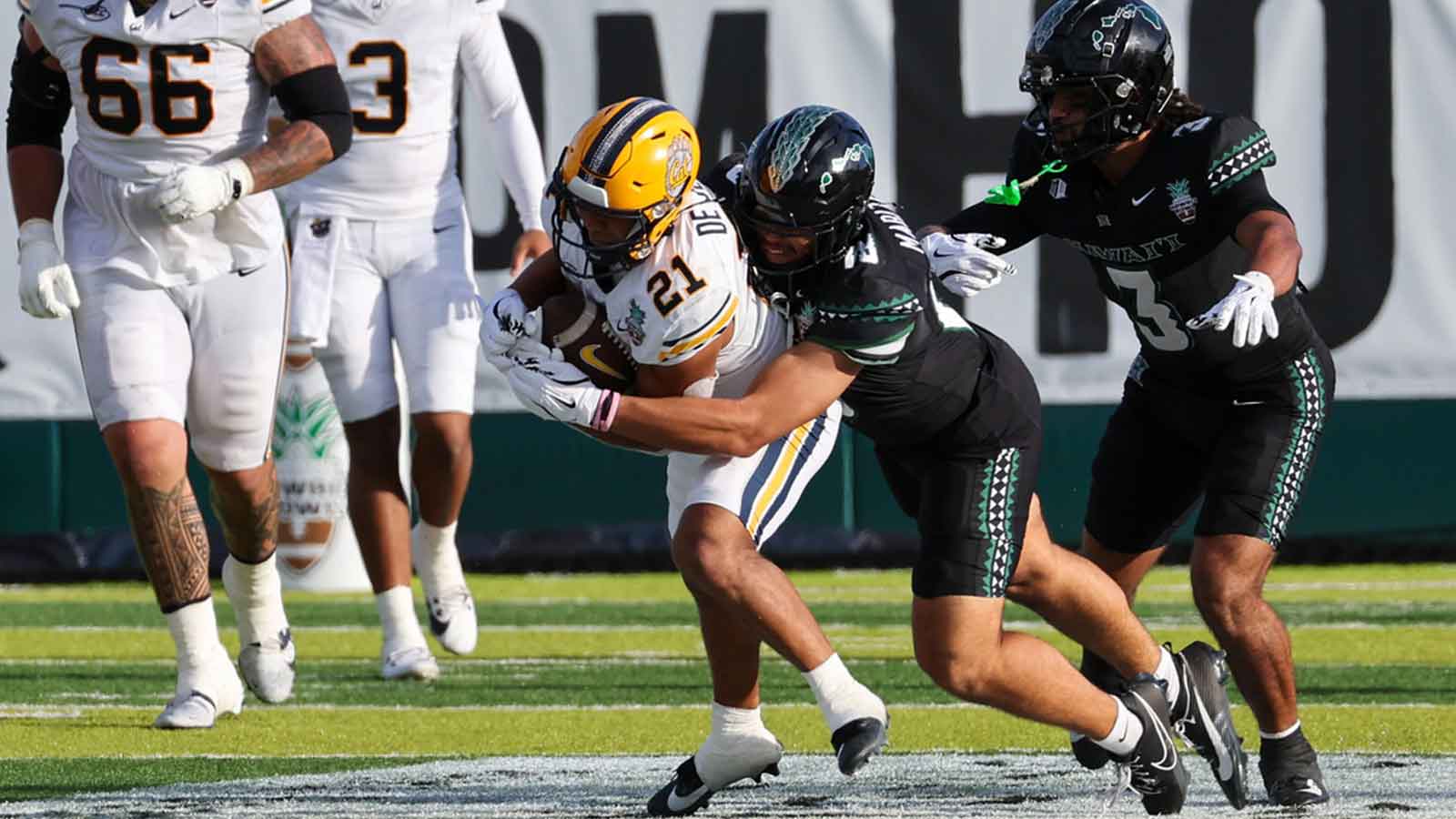 Hawaii Rainbow Warriors linebacker Zaden Mariteragi (18) brings down California Golden Bears wide receiver Jacob De Jesus (21) during the second quarter at the Hawaii Bowl at the Clarence T.C. Ching Athletics Complex.