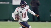 Chicago Bears quarterback Caleb Williams (18) runs for a first down during the third quarter of their game against the Green Bay Packers Sunday, December 7, 2025 at Lambeau Field in Green Bay, Wisconsin.