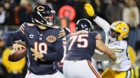 Chicago Bears quarterback Caleb Williams (18) prepares to throw a pass and offensive tackle Ozzy Trapilo (75) blocks against Green Bay Packers defensive end Rashan Gary (52) during the first quarter at Soldier Field. Mandatory Credit: Mike Dinovo-Imagn Images