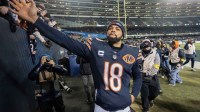 Chicago Bears quarterback Caleb Williams (18) high fives fans after defeating the Green Bay Packers during overtime at Soldier Field.