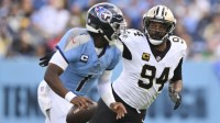 New Orleans Saints defensive end Cameron Jordan (94) gives chase to Tennessee Titans quarterback Cam Ward (1) during the second half of the game at Nissan Stadium.