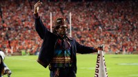 Former Auburn quarterback Cam Newton cheers on his team from the sideline as Auburn Tigers take on Georgia Bulldogs at Jordan-Hare Stadium in Auburn, Ala. on Saturday, Oct. 11, 2025. Auburn Tigers lead Georgia Bulldogs 10-3 at halftime.