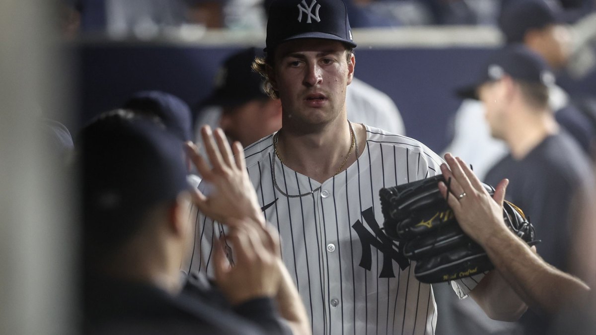 New York Yankees starting pitcher Cam Schlitter (31) is greeted in the dugout after getting taken out of the game against the Seattle Mariners in the sixth inning at Yankee Stadium.