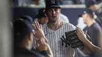 New York Yankees starting pitcher Cam Schlitter (31) is greeted in the dugout after getting taken out of the game against the Seattle Mariners in the sixth inning at Yankee Stadium.