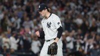 New York Yankees pitcher Cam Schlittler (31) pumps his fist as he leaves the field after pitching the eighth inning against the Boston Red Sox during game three of the Wildcard round for the 2025 MLB playoffs at Yankee Stadium.