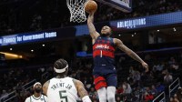 Washington Wizards forward Cam Whitmore (1) dunks the ball as Milwaukee Bucks guard Gary Trent Jr. (5) looks on in the second half at Capital One Arena.