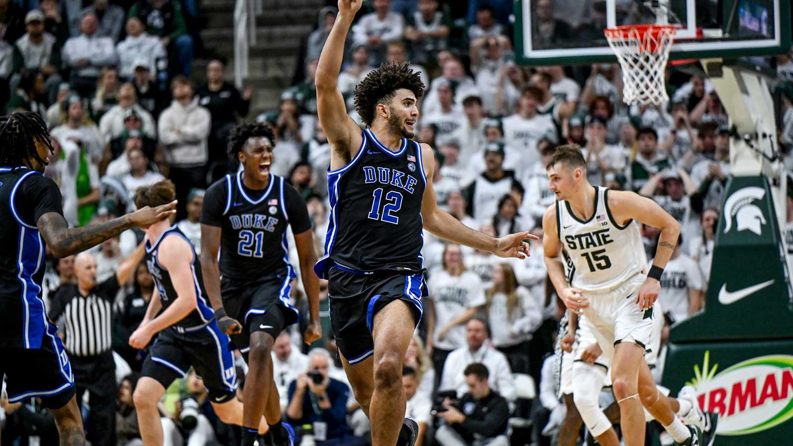 Duke's Cameron Boozer, center, celebrates after teammate Caleb Foster's 3-pointer against Michigan State during the second half on Saturday, Dec. 6, 2025, at the Breslin Center in East Lansing.