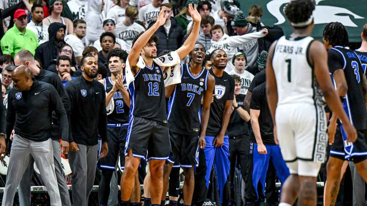 Duke's Cameron Boozer, center, waves to Michigan State fans as the Blue Devils begin celebrating during the second half in the game against Michigan State.