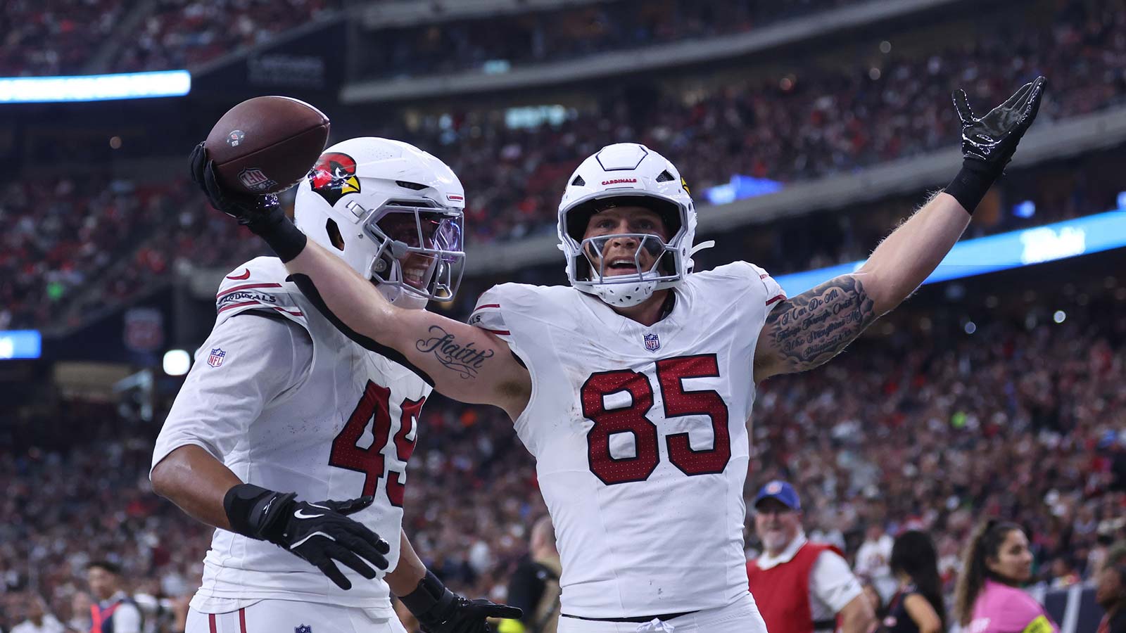 Arizona Cardinals tight end Trey McBride (85) and tight end Pharaoh Brown (49) celebrate a touchdown during the second quarter against the Houston Texans at NRG Stadium.
