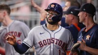 Houston Astros third baseman Carlos Correa (1) celebrates with teammates after scoring a run against the Atlanta Braves in the fifth inning at Truist Park.