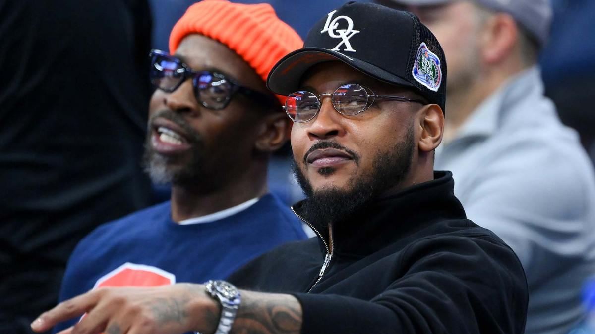 Former professional basketball player Carmelo Anthony (right) looks on prior to the game between the Saint Joseph's Hawks and the Syracuse Orange at the JMA Wireless Dome.