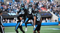 Carolina Panthers quarterback Bryce Young (9) reacts with wide receiver Jimmy Horn Jr. (15) as running back Chuba Hubbard (30) is in the foreground in the third quarter at Bank of America Stadium.