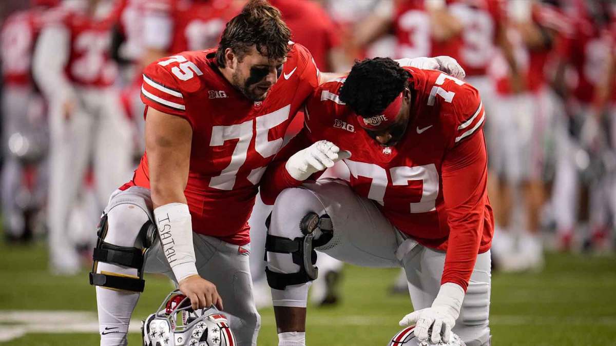 Ohio State Buckeyes offensive linemen Carson Hinzman (75) and Tegra Tshabola (77) pray prior to the NCAA football game against the UCLA Bruins at Ohio Stadium in Columbus.