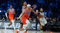 San Antonio Spurs guard Devin Vassell (24) battles with Oklahoma City Thunder guard Alex Caruso for the loose ball during the fourth quarter at T-Mobile Arena.