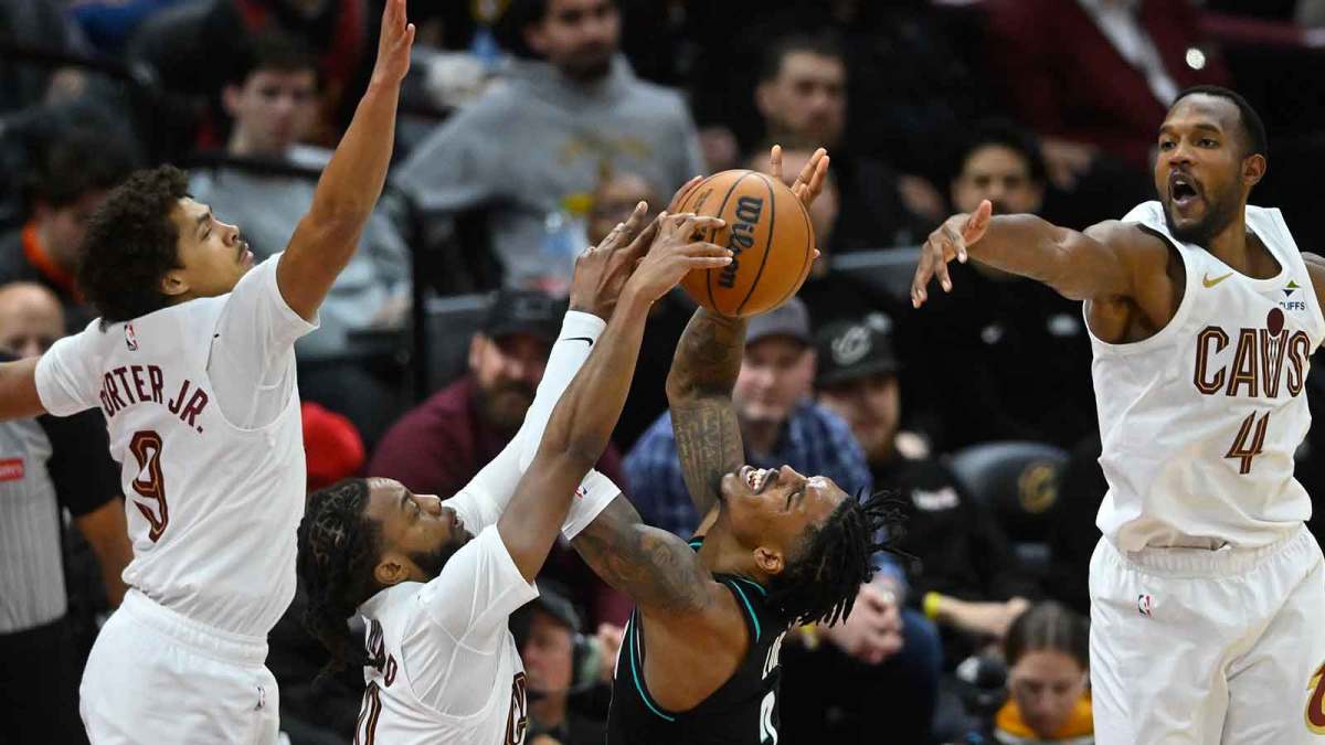 Portland Trail Blazers guard Caleb Love (2) shoots against Cleveland Cavaliers guard Craig Porter Jr. (9), guard Darius Garland (10) and center Evan Mobley (4) in the fourth quarter at Rocket Arena.