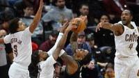 Portland Trail Blazers guard Caleb Love (2) shoots against Cleveland Cavaliers guard Craig Porter Jr. (9), guard Darius Garland (10) and center Evan Mobley (4) in the fourth quarter at Rocket Arena.
